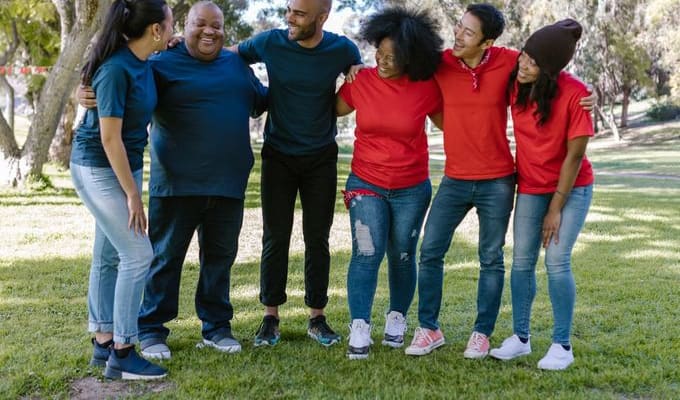 A diverse group of friends smiling together in the park
